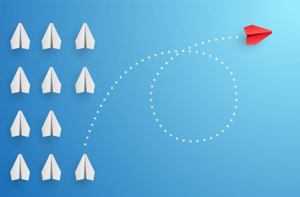 istock Individuality concept. Individual and unique leader red paper plane flies to the side 1323648732