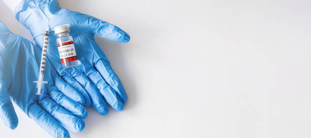 istock Covid-19 coronavirus vaccine bottle and syringe injection tool for covid19 immunization treatment on doctor hand. Healthcare and Medical concept. 1323649121