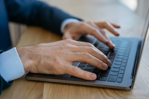 istock Man hands typing on keyboard. Businessman using laptop computer, searching information on website, sitting in office. Freelancer working from home 1323649893
