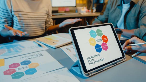istock Asia businesspeople meeting plan analysis statistics brainstorm and header of team hold tablet point graph chart and employee take note in modern home office night. 1323650110