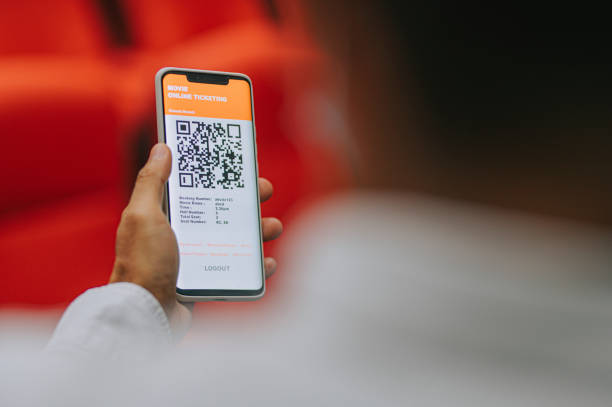 istock asian chinese man using mobile app cinema movie e-ticketing reservation looking for seat inside cinema hall 1323650236