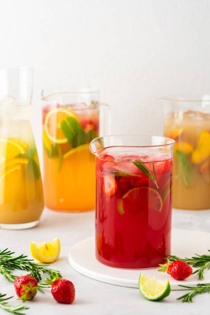 istock Jugs of refreshing fruit drinks with fruit wedges 1323651525