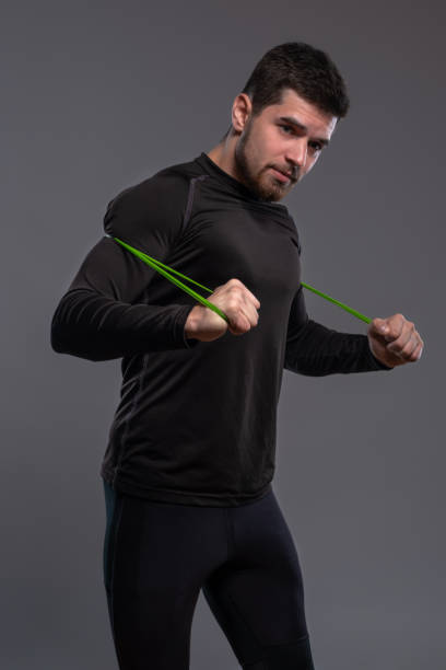 istock Concentrated athlete stretching resistance elastic band with hands 1323651745