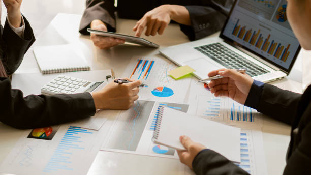 istock Business group meetings Talk about graph analysis with calculators and laptops with tablets on the office table. 1323651764