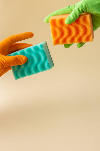 istock Hand in rubber gloves hold a dishwashing sponge 1323651856