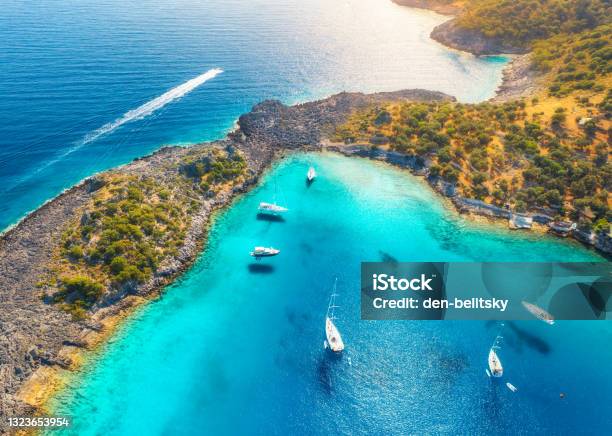 Aerial View Of Beautiful Yachts And Boats On The Sea At Sunset In Summer Akvaryum Koyu In Turkey Top View Of Luxury Yachts Sailboats Clear Blue Water Rock Sky Mountain And Green Trees Travel Stock Photo - Download Image Now