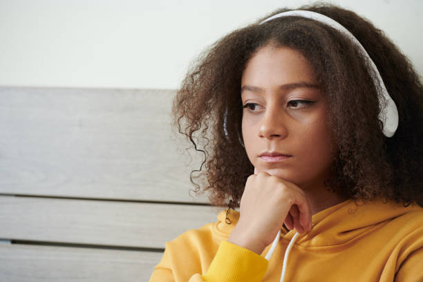 adolescente pensive dans des écouteurs blancs - child blank expression pensive focus on foreground photos et images de collection