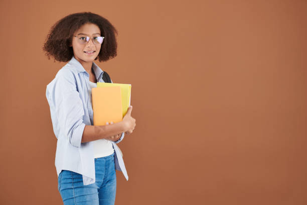 istock Smiling Mixed-race Girl with Books 1323655404