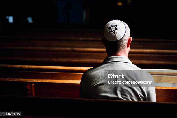Young Jewish Man Wearing Skull Cap Praying Inside Synagogue Stock Photo - Download Image Now