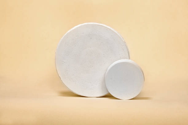 istock Empty white  podium on pastel beige color background. Minimal boxes and geometric podium. Scene with geometrical forms. Empty showcase for cosmetic product presentation. Fashion magazine. 1323657868