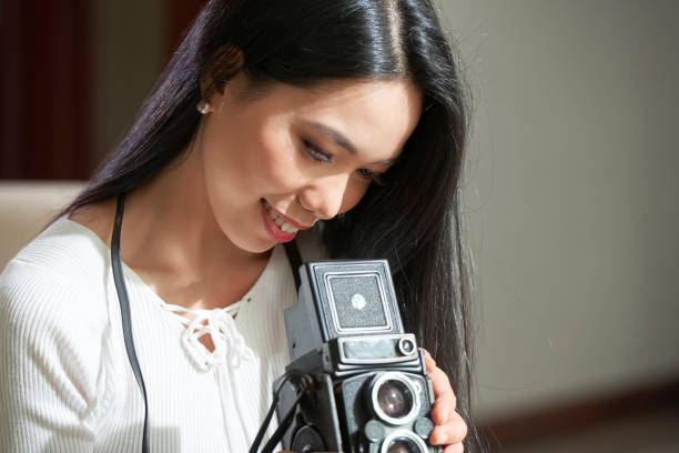 istock Satisfied Asian Photographer with Camera 1323660476
