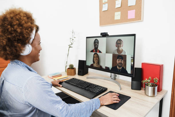 istock Senior african woman having video call with her colleagues using computer app - Focus on right hand 1323660731