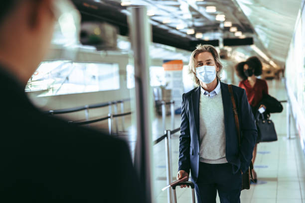 istock People traveling by airplane during covid-19 1323662593