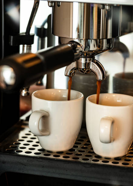 istock Close up image of professional espresso machine pouring in two cups 1323662629