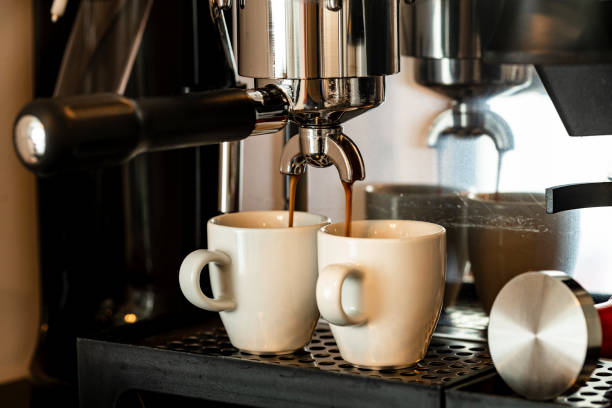istock Close up image of professional espresso machine pouring in two cups 1323662730