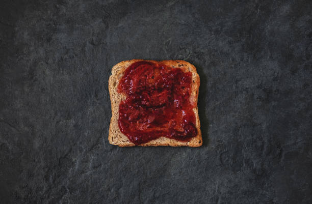 istock Strawberry jam toast, breakfast - Isolated on stone background, rye bread 1323665367