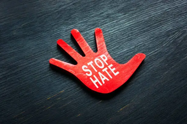 Photo of Stop hate phrase on the small hand.