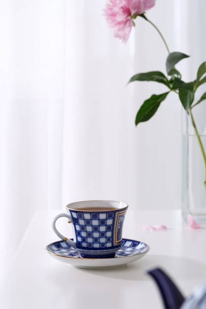istock Fresh tea in a beautiful ceramic cup on a white table. Light background. 1323668561