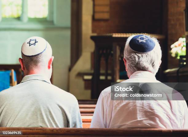 Jewish Men Sitting Together And Praying Inside Synagogue Stock Photo - Download Image Now