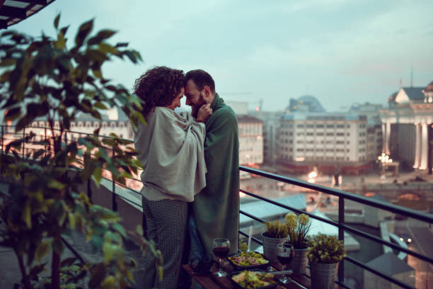 istock Embracing Couple Warming Up With Blankets And Enjoying Rooftop Dinner Date 1323669744