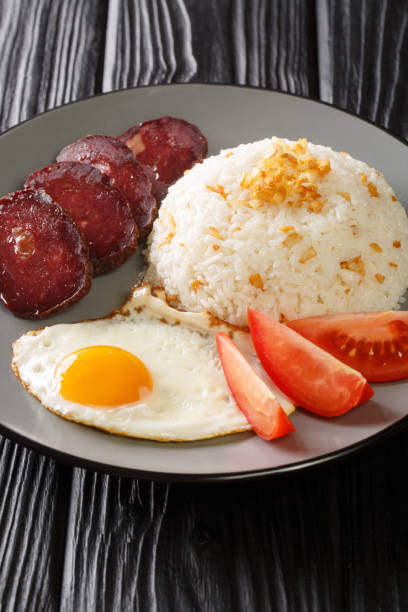 istock Garlic rice served with fried egg and jerky close-up in a plate. vertical 1323671076