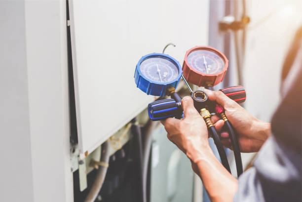 Air repair mechanic using measuring equipment for filling industrial factory air conditioners and checking maintenance outdoor air compressor unit. air condition outdoor unit compressor install outside the building. train air conditioner stock pictures, royalty-free photos & images