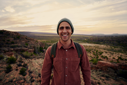 Portrait of successful happy male hiker looking at camera