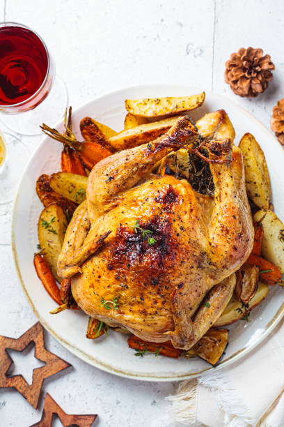 istock Christmas baked whole chicken stuffed with thyme, lemon and vegetables. 1323674221