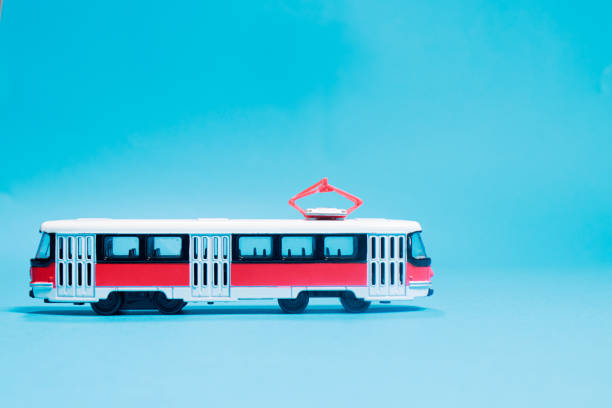 istock Children's toy red white tram on a blue background copy space for text. 1323674336