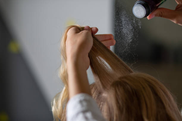istock Stylist's hand applying volume hair powder 1323676825