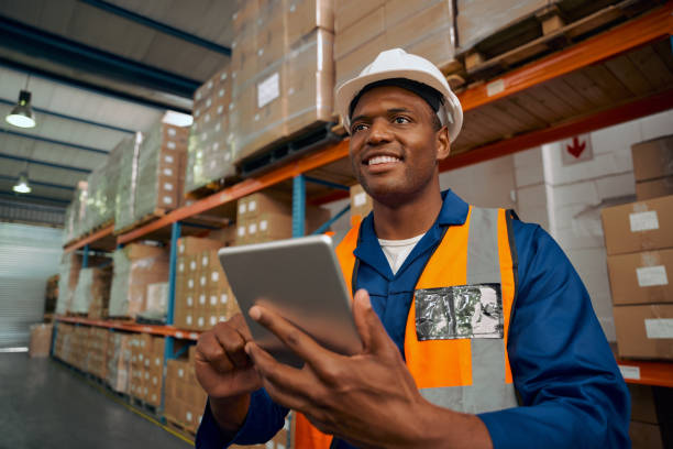 istock Smiling factory worker inspecting the manufacture goods using digital tablet in warehouse 1323677454