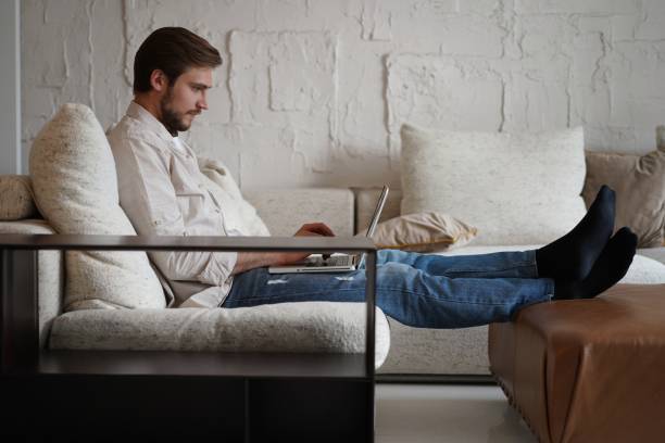 istock Male remote working from home and having work confrence video call. 1323679034