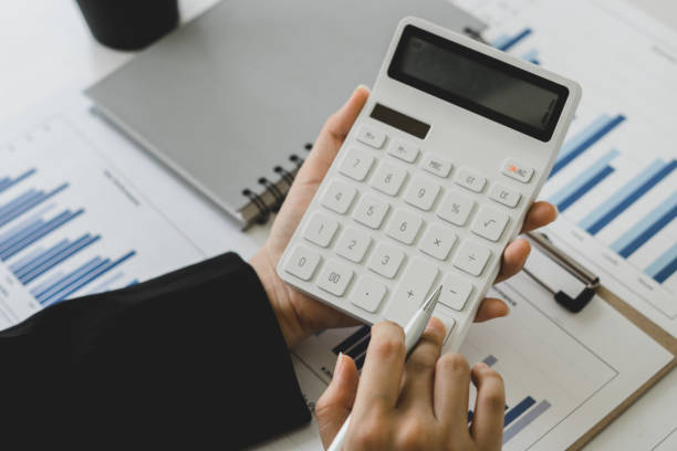 istock bookkeeper or financial inspector hands making report, calculating or checking balance. Home finances, investment, economy, saving money or insurance concept 1323681208