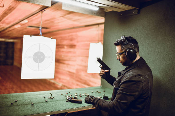istock Male Comparing Pistol To Revolver On Shooting Range 1323681286