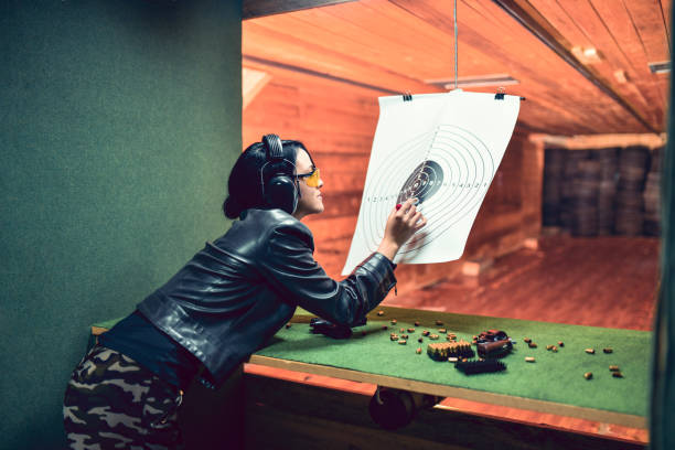 istock Female Shooting Competitor Marking Shooting Results On Target 1323681306