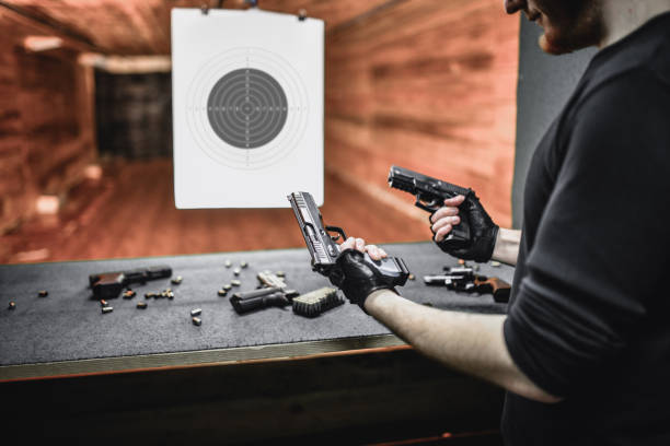 istock Male Shooter Comparing Different Pistol Weight On Gun Range 1323682005