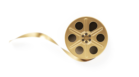 Gold colored film reel on white background. Horizontal composition with clipping path and copy space.