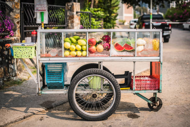 Cart for selling fruit on the beach road, Pattaya Cart for selling fruit on the beach road, Pattaya, Thailand. fruit cart vendor stock pictures, royalty-free photos & images