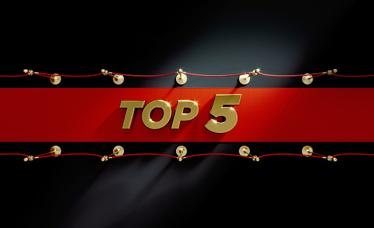 Top 5 sitting on red carpet over black background. Horizontal composition with copy space. Directly above. Top 5 red carpet concept.