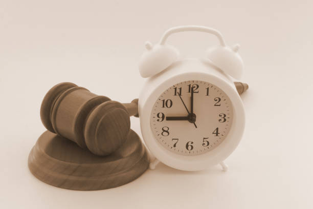 istock Wooden judge gave and alarm clock. 1323684011