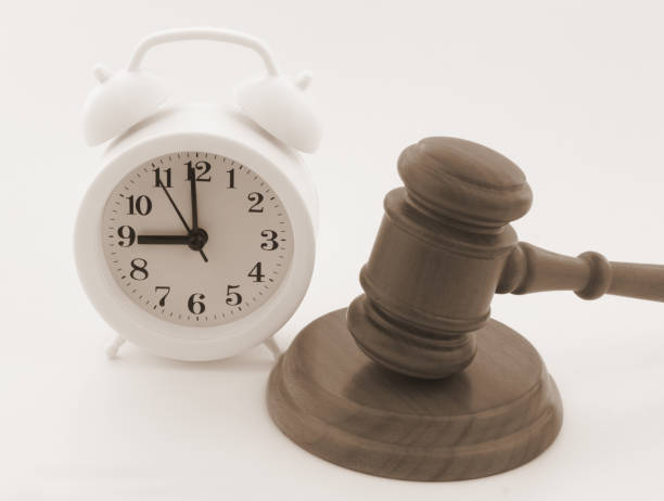 istock Wooden judge gave and alarm clock. 1323684014