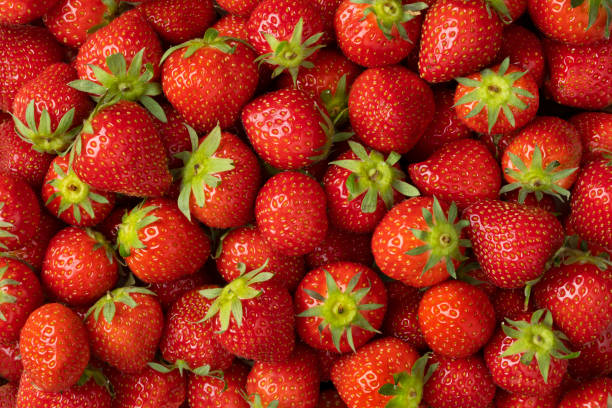 istock Whole fresh strawberries close up full frame 1323689965