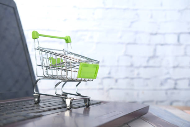 istock Empty shopping trolly cart on keyboard. 1323691418
