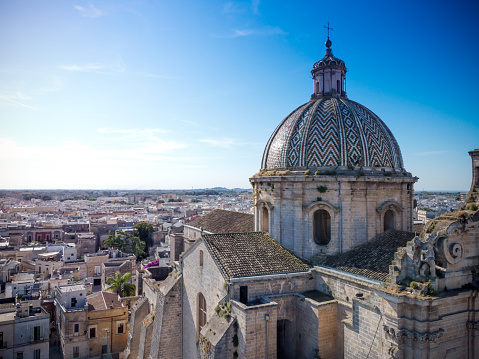 aerial view of the Basilica Pontificia Minore del Santissimo Rosario in the town of Francavilla Fontana, in the south of Italy on Blurred background