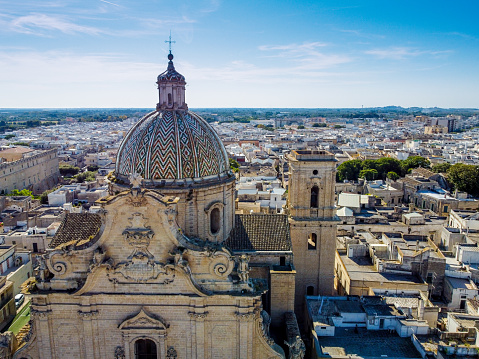 aerial view of the Basilica Pontificia Minore del Santissimo Rosario in the town of Francavilla Fontana, in the south of Italy on Blurred background