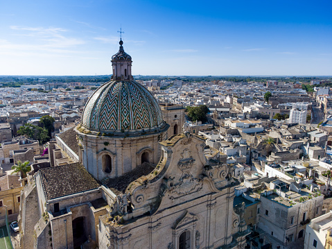 aerial view of the Basilica Pontificia Minore del Santissimo Rosario in the town of Francavilla Fontana, in the south of Italy on Blurred background