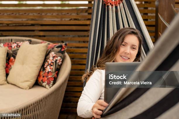 Woman Making Video Call On Laptop Sitting In Hammock Stock Photo - Download Image Now