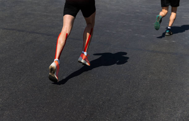 istock legs two male runners run marathon on dark asphalt 1323694710