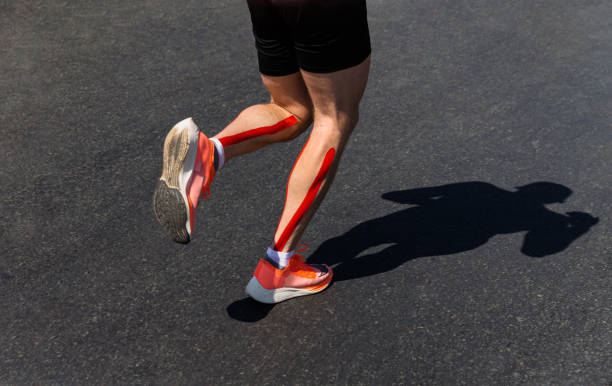 male runner legs on calf kinesio taping run marathon - kinesio imagens e fotografias de stock