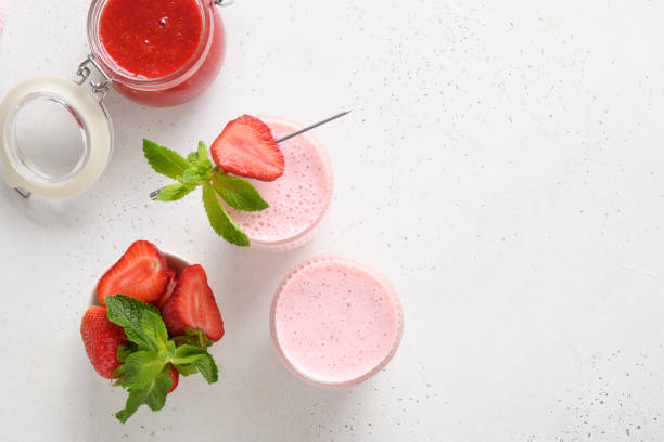 istock Indian strawberry lassi or milkshake on white background 1323694721